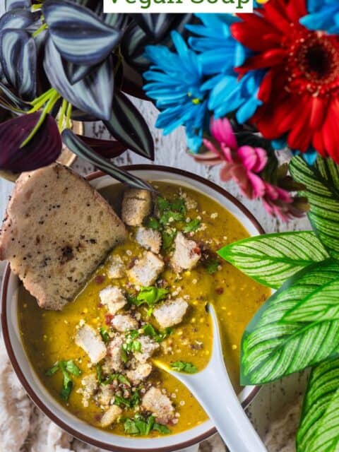 Indian Lentil Soup served in a bowl with bread and text at the top.