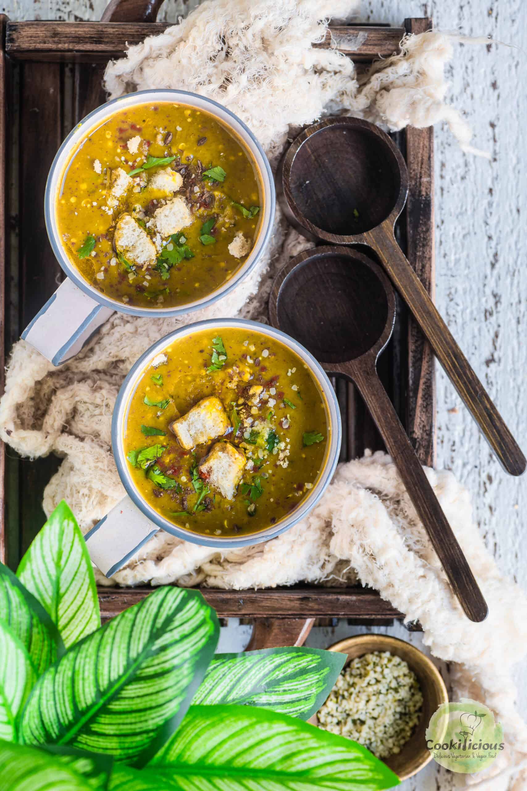 2 bowls of Dal Shorba served in mugs.