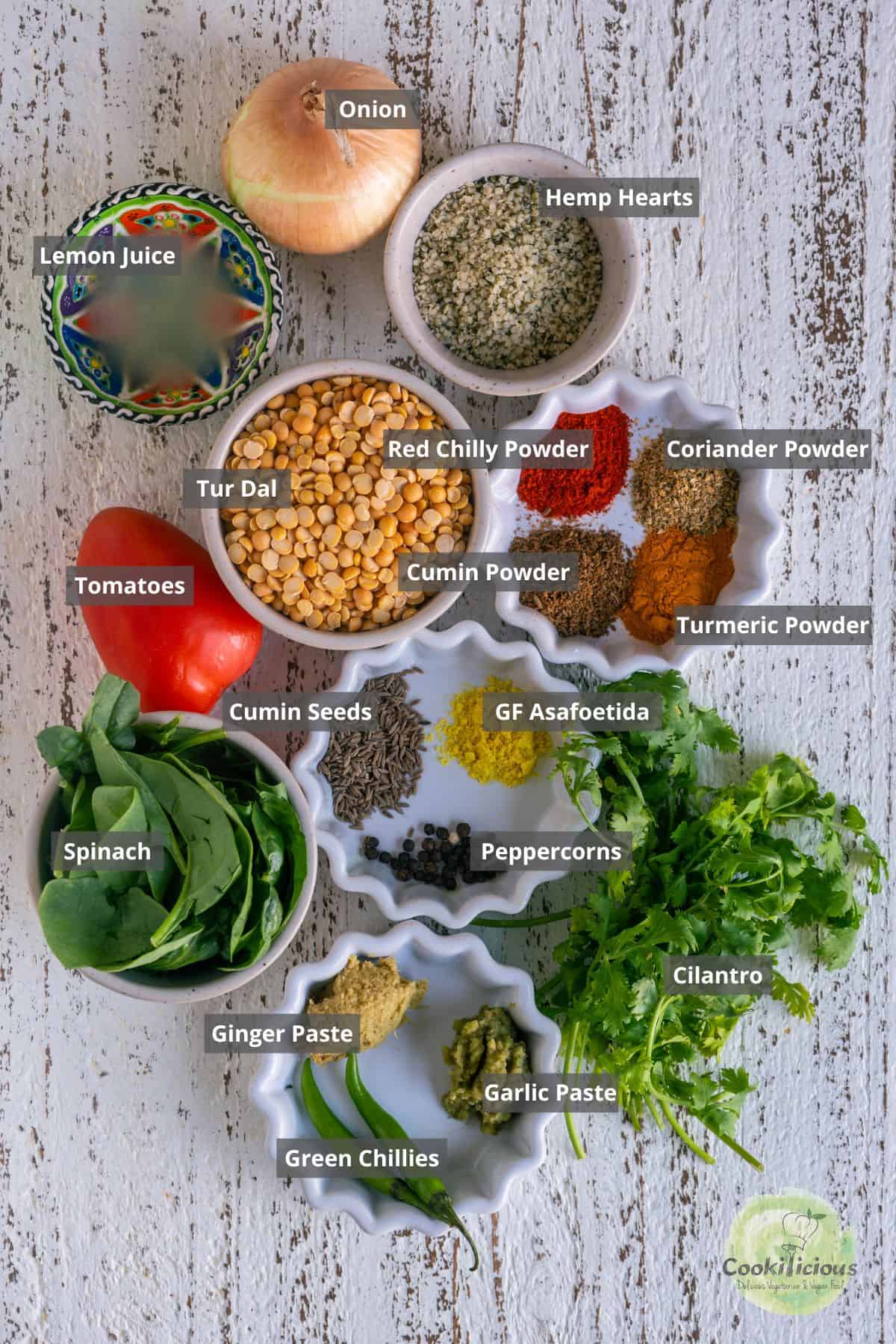 All the ingredients needed to make vegan Indian Lentil Soup placed on a table with labels on them.