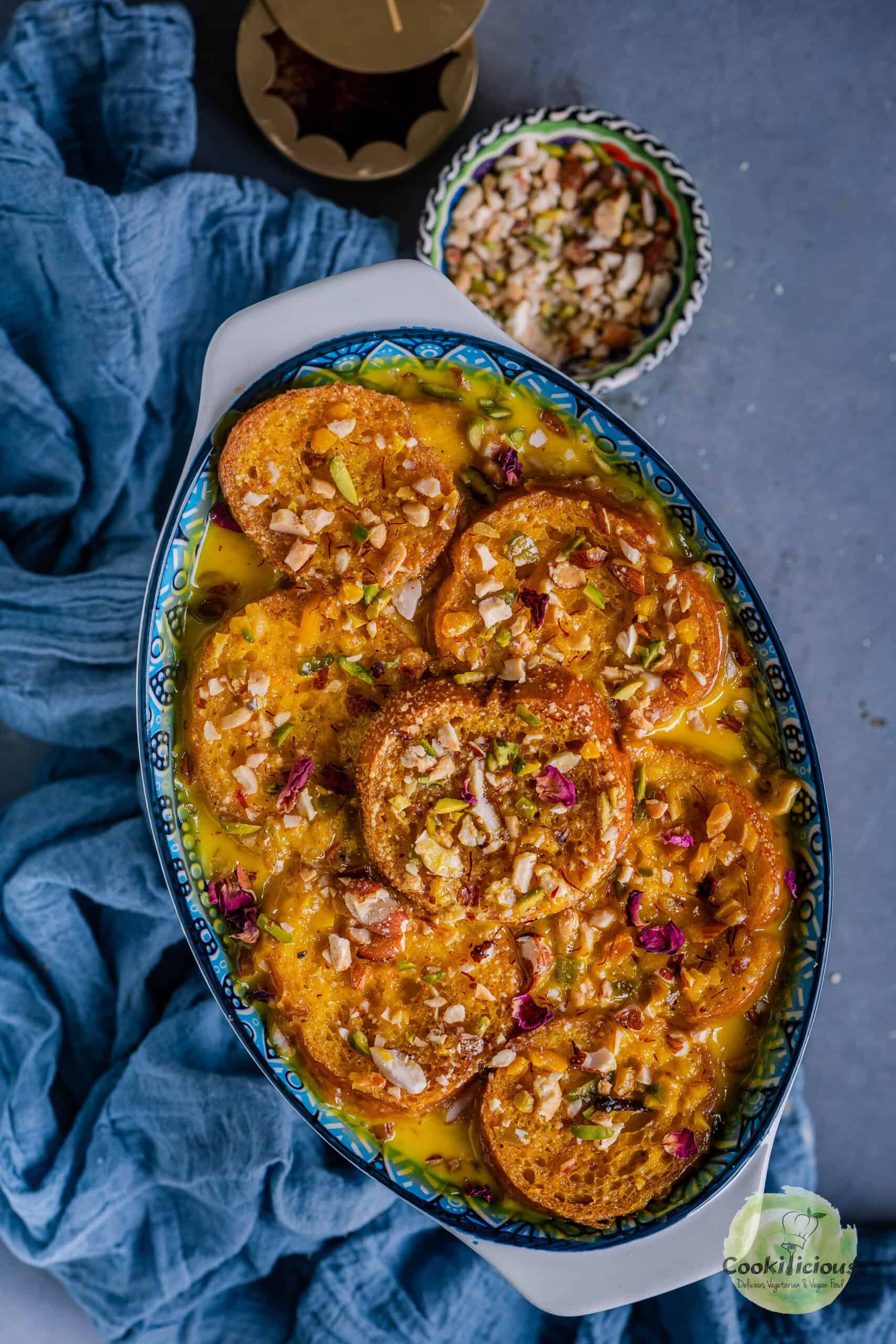 Shahi Tukda garnished with chopped nuts, and rose petals.