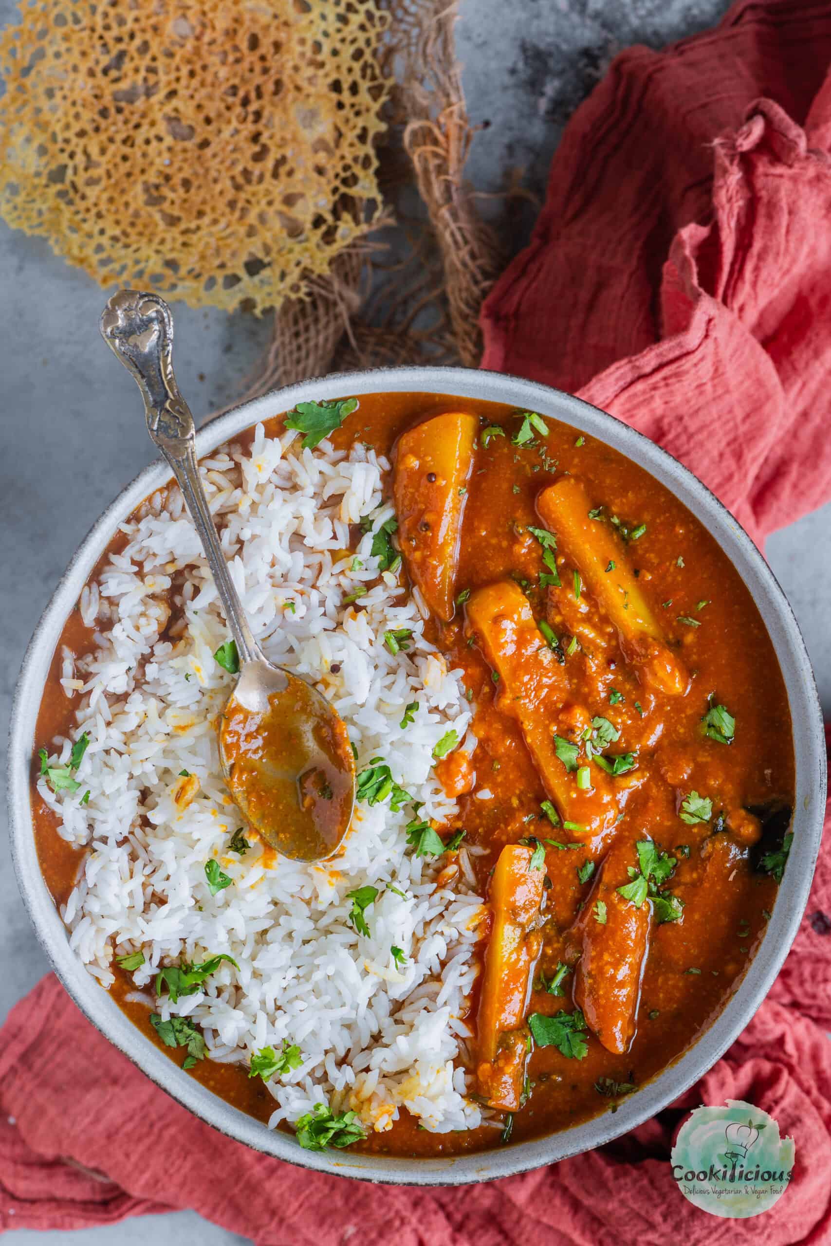 Sindhi Aloo Kadhi served with rice in a bowl.