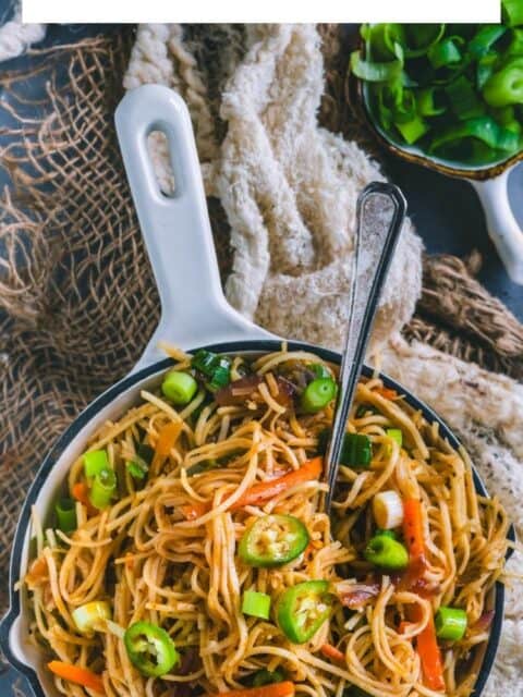 Veg Hakka Noodles served in a bowl with a fork in it and text at the top.