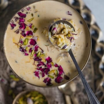 Instant Pot Rice Kheer served in a bowl with a spoon in it.