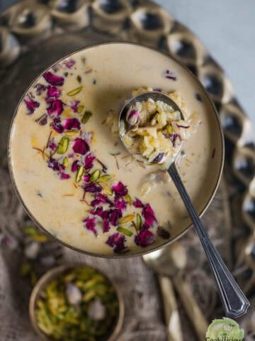 Instant Pot Rice Kheer served in a bowl with a spoon in it.