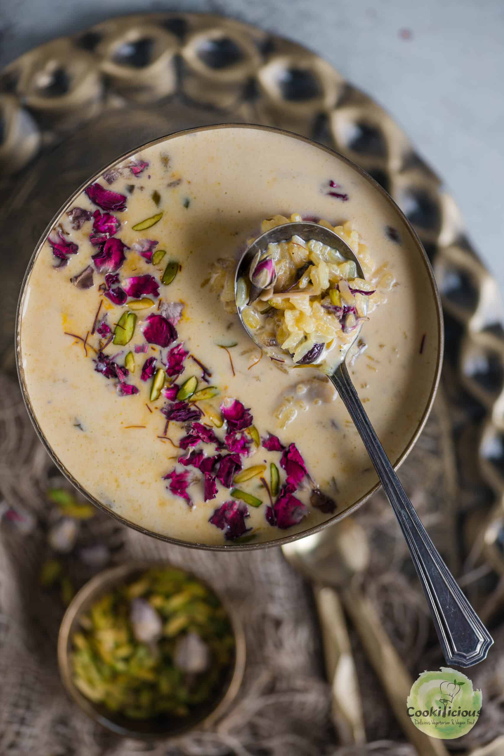 Instant Pot Rice Kheer served in a bowl with a spoon in it.