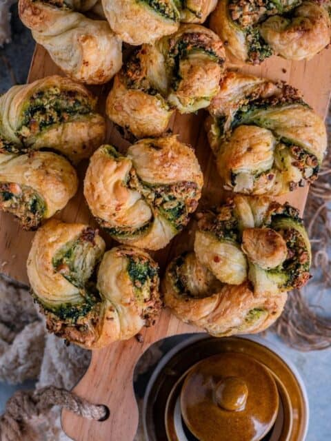 Flaky Spinach Puffs with paneer served in a tray and text at the top.