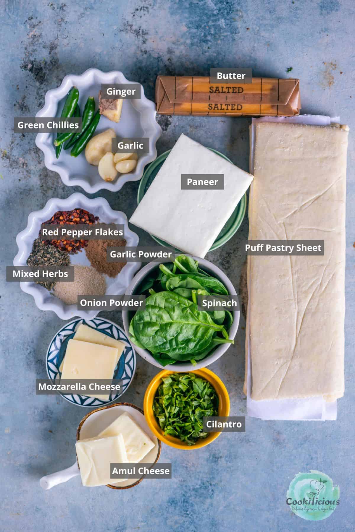 all the ingredients needed to make Spinach Puffs with Paneer placed on a table with labels on them.