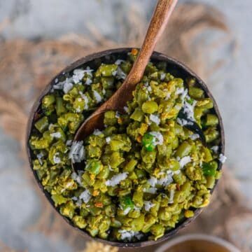 Beans Poriyal served in a bowl with a spoon in it.