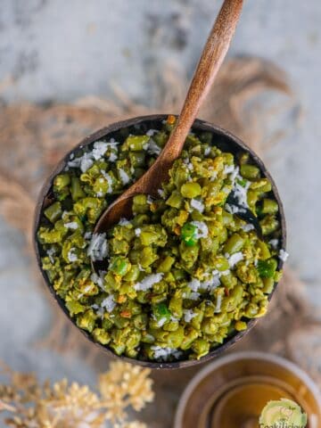 Beans Poriyal served in a bowl with a spoon in it.