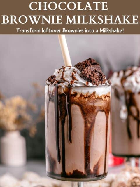 A single tall glass of brownie milkshake served with a straw and garnished with a fudgy brownie wedge and text at the top and bottom.