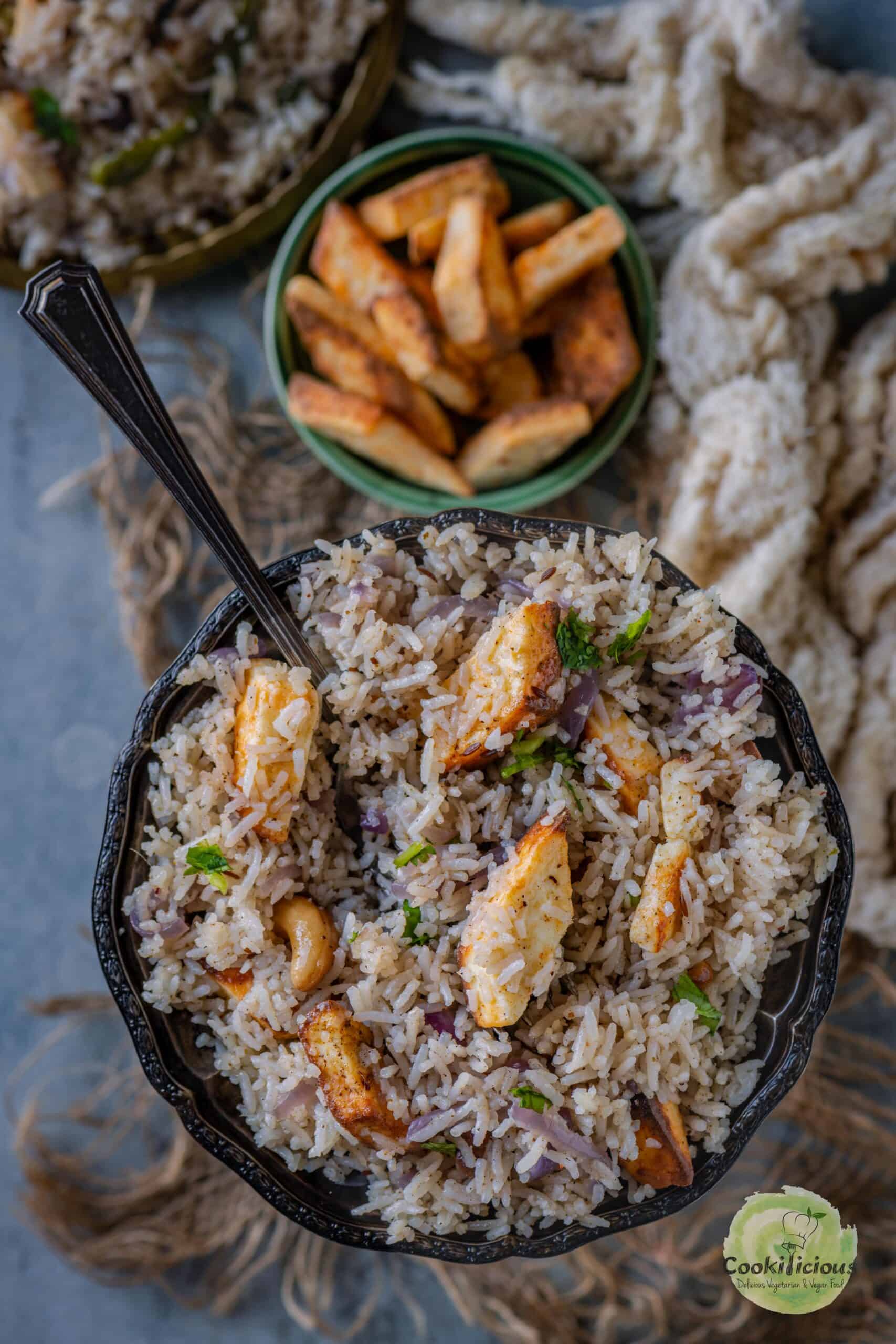 A bowl of fragrant Paneer Rice showcasing fluffy basmati rice and golden paneer cubes, served in a bowl.