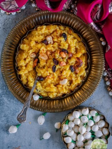 Tamil Sweet Pongal served in a bowl with a spoon in it.