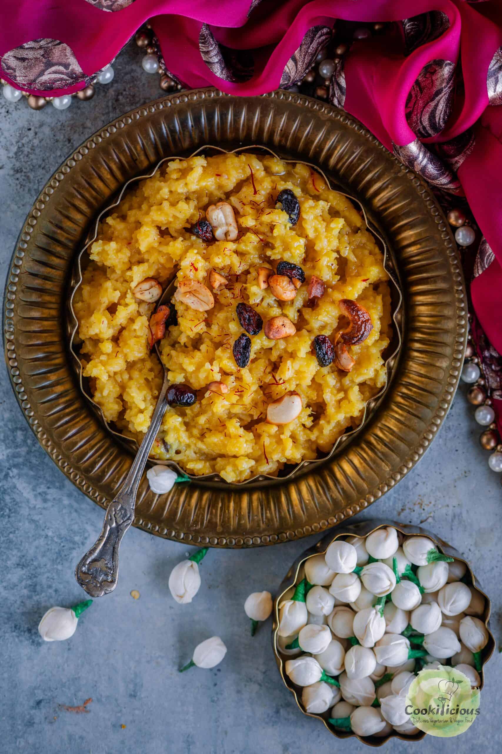 Tamil Sweet Pongal served in a bowl with a spoon in it.