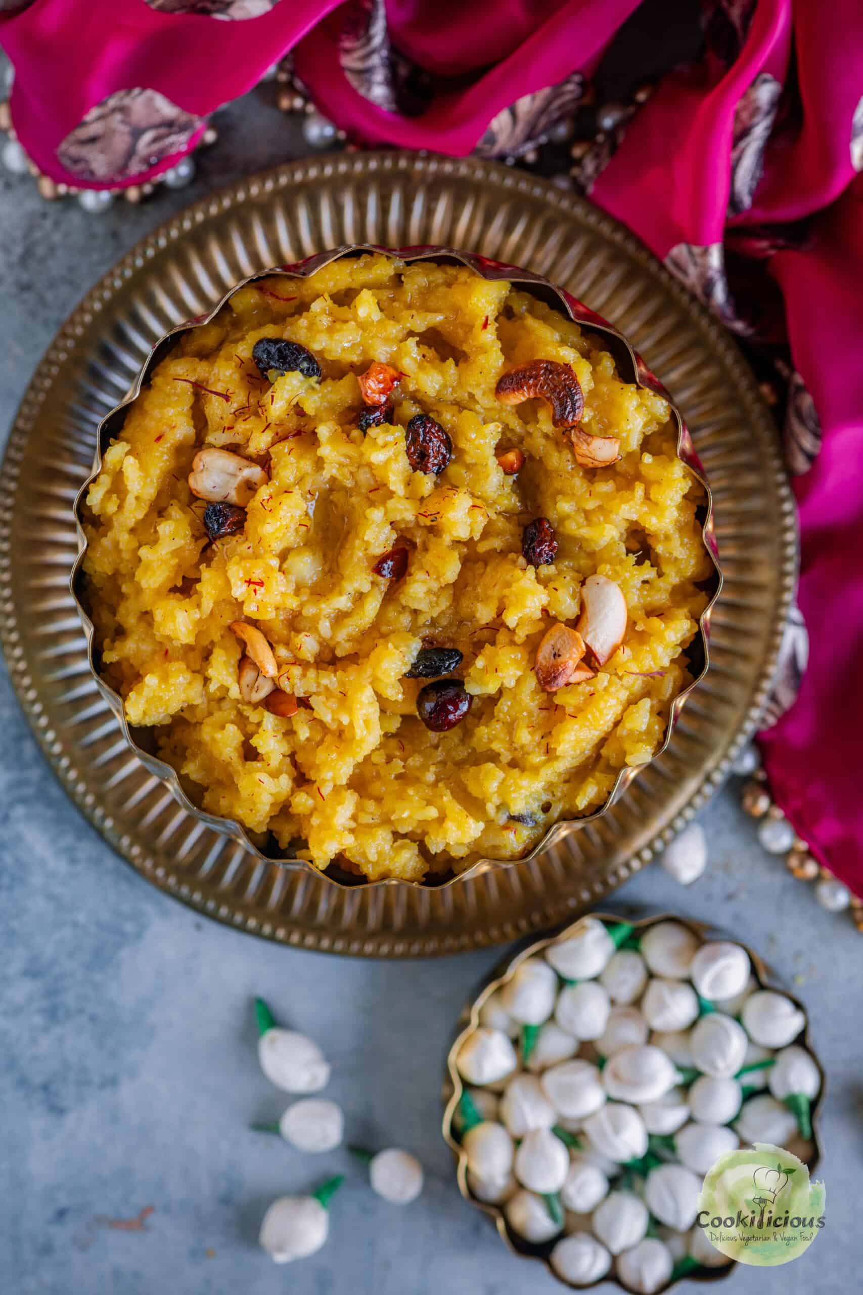 Sakkara Pongal garnished with fried nuts and served in a bowl.