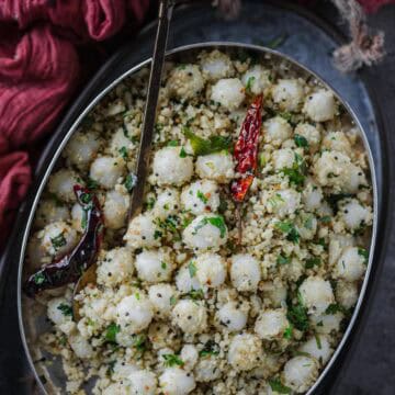 Ammini Kozhukattai served in an oval platter with a spoon in it.