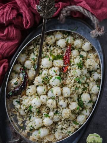 Ammini Kozhukattai served in an oval platter with a spoon in it.