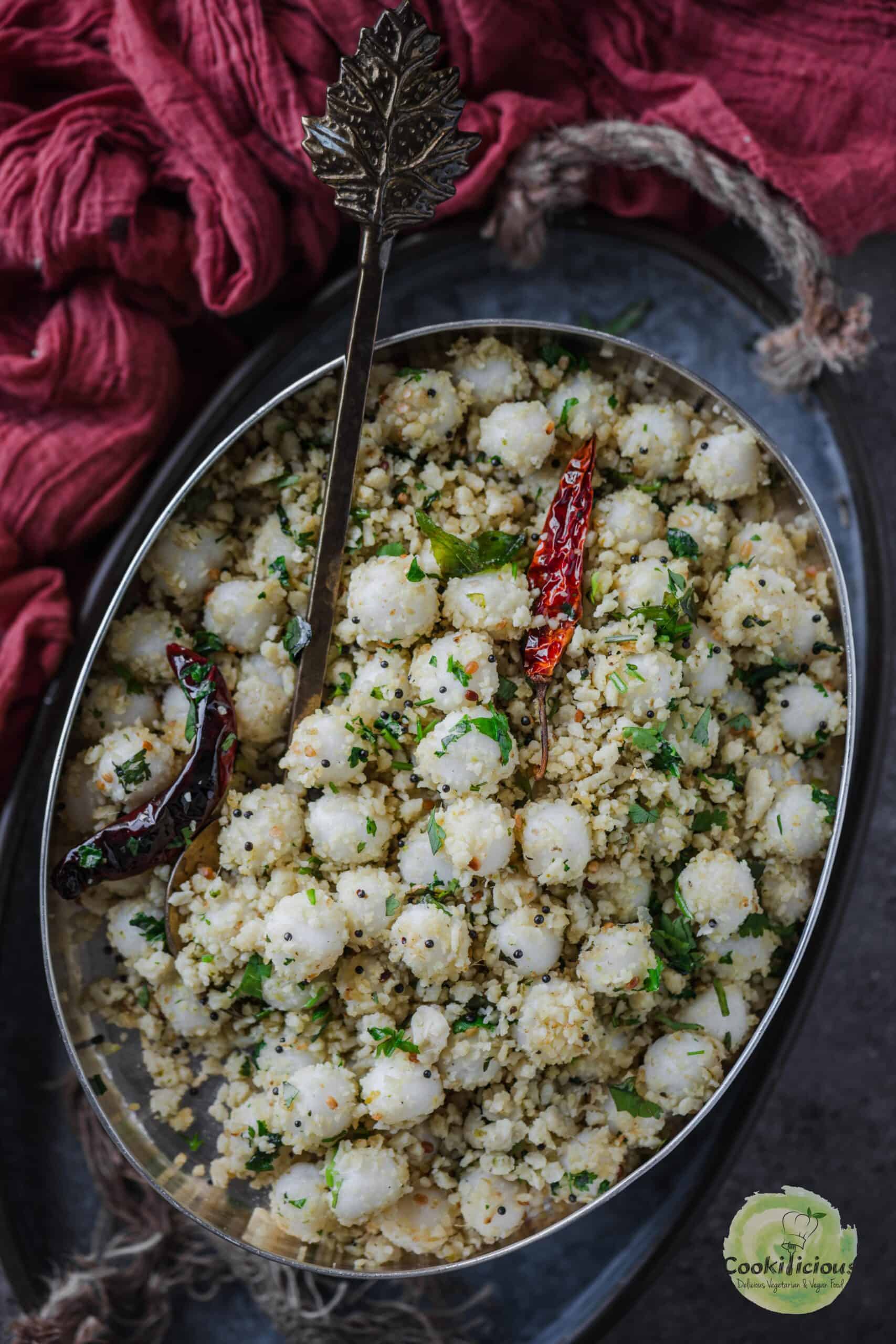 Ammini Kozhukattai served in an oval platter with a spoon in it. 