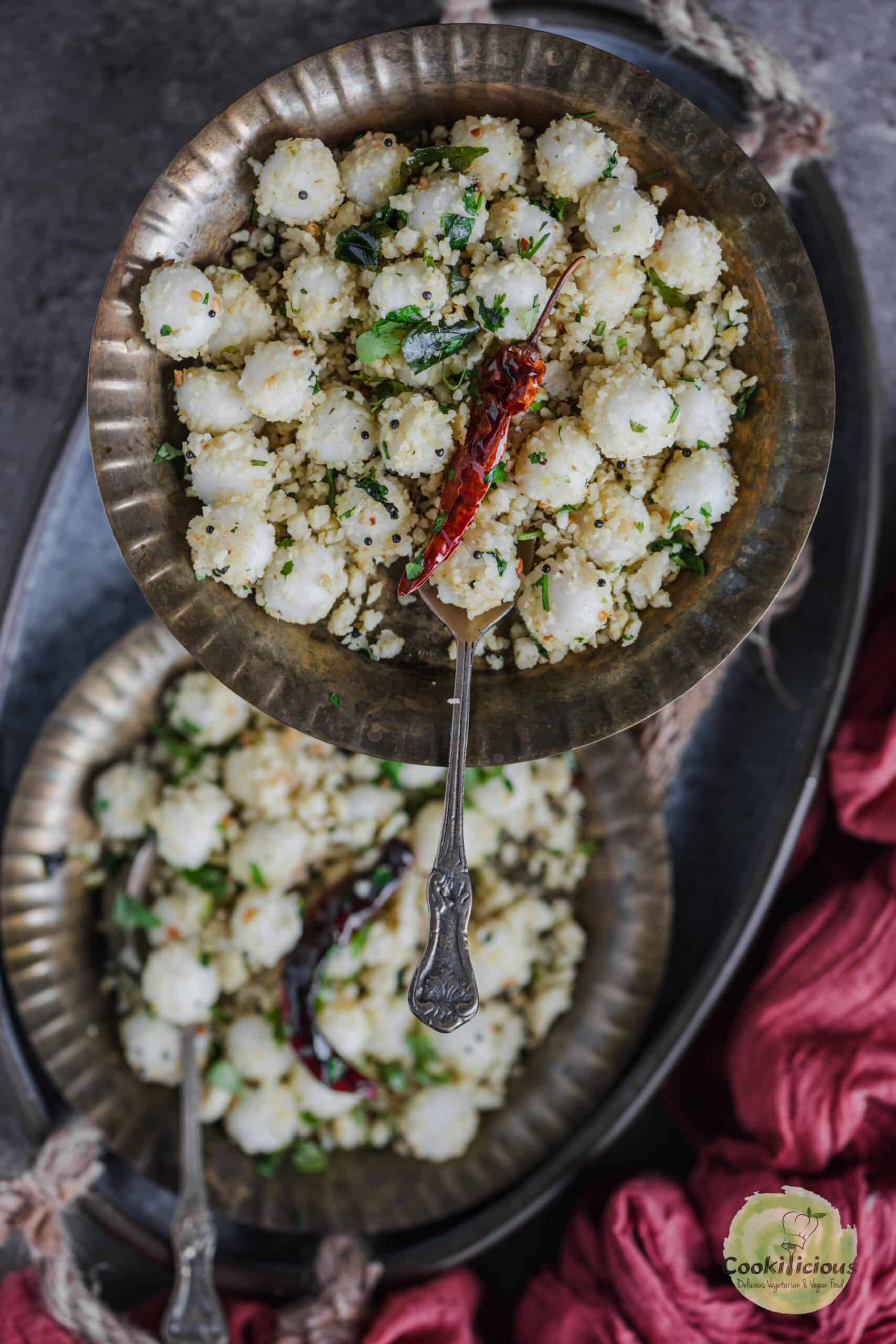 Ammini Kozhukattai served in a plate with a spoon in it.