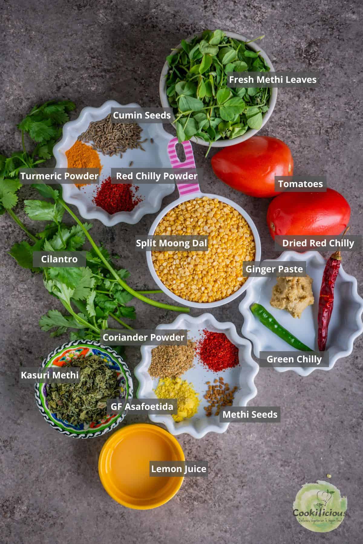 All the ingredients needed to make Methi Dal at home placed on a table with labels on them.