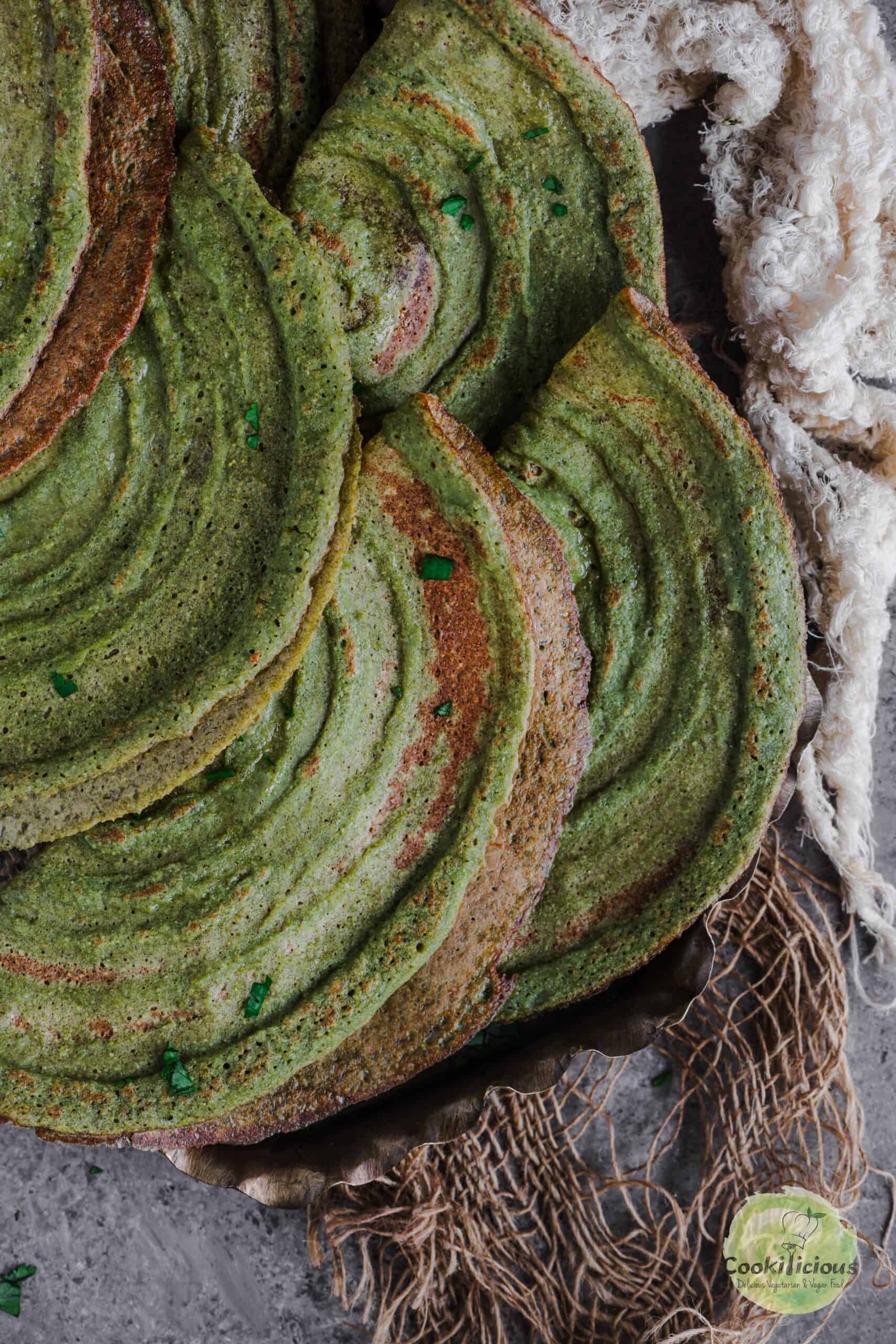 A couple of folded Pesarattu served in a plate.