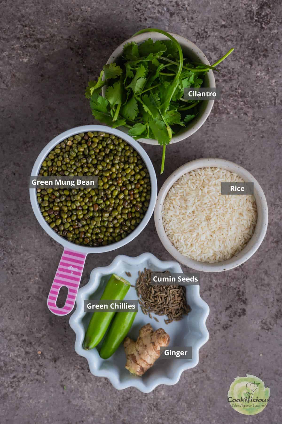 All the ingredients needed to make Pesarattu Dosa placed on a table with labels on them.