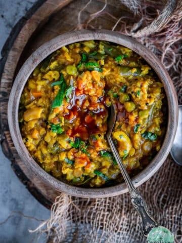 A top view of Instant Pot Oats Upma served with some ketchup.