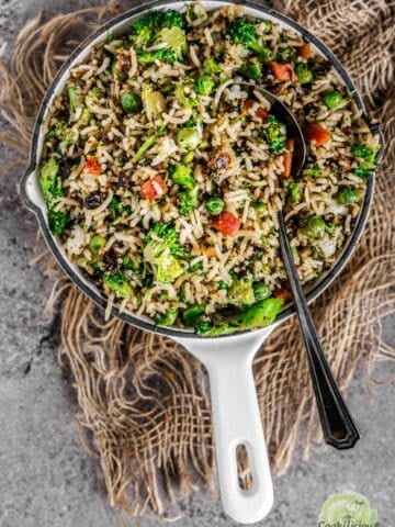 Broccoli fried rice served in a platter with a spoon in it.