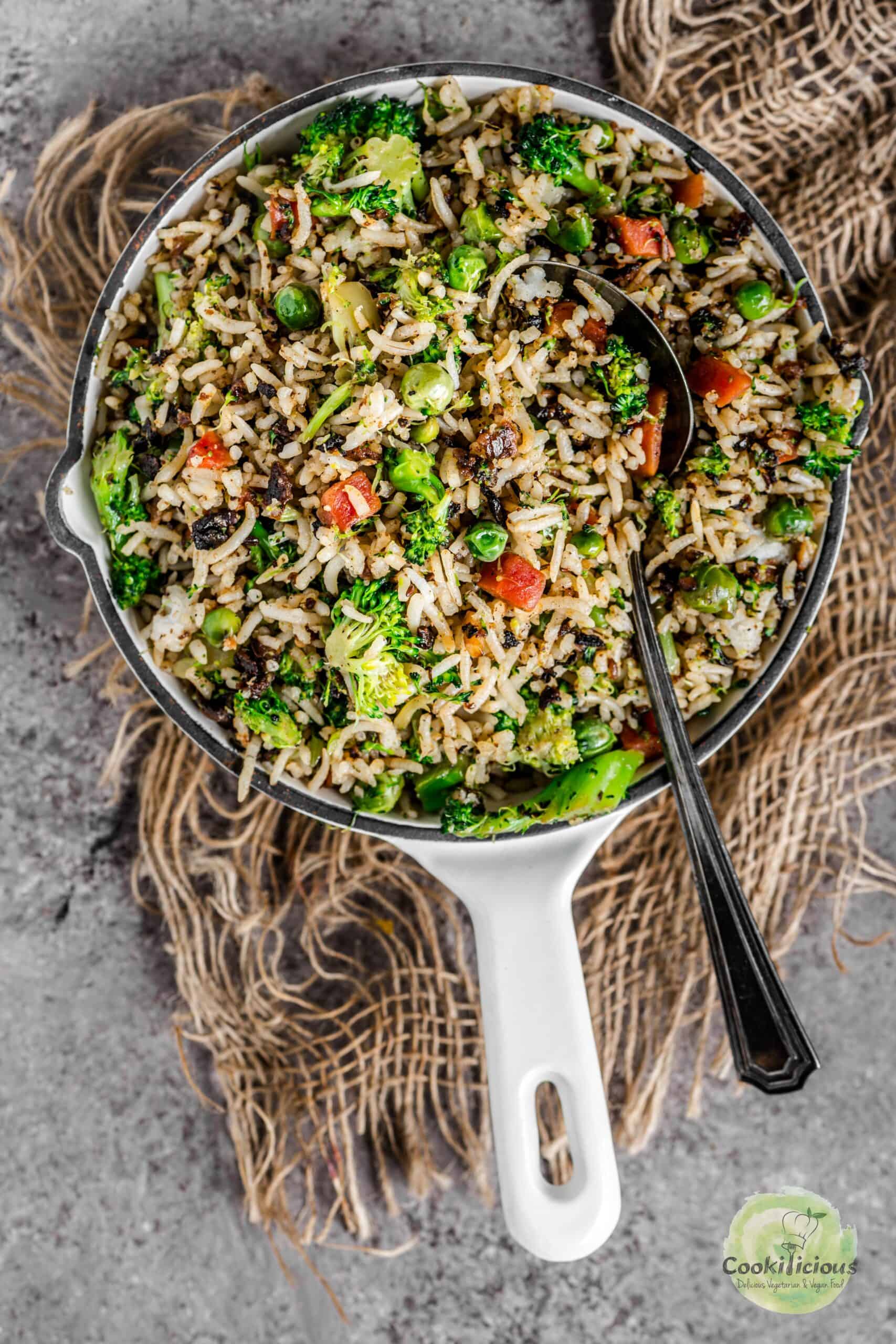 Broccoli fried rice served in a platter with a spoon in it.