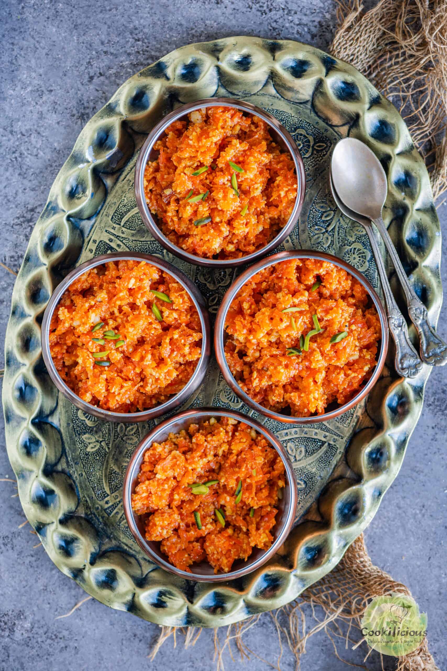 Carrot Halwa served in 4 small bowls placed on a tray.