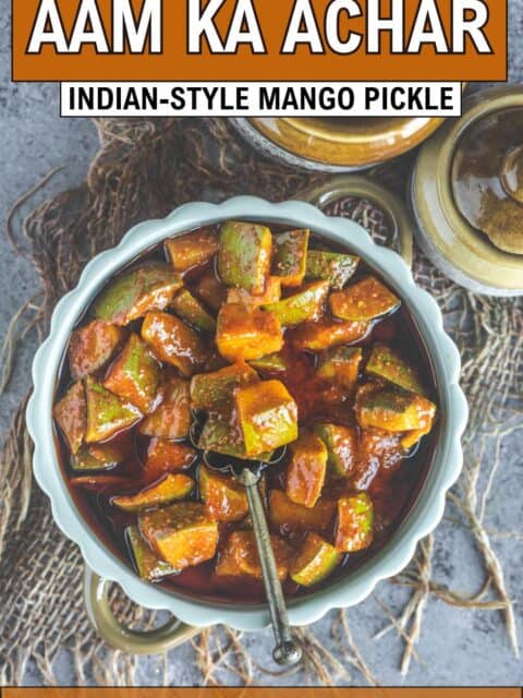 Authentic South Indian-style mango pickle with visible chunks of raw mango and Indian spices and text at the top and bottom.