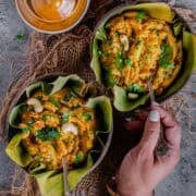Tomato rava upma served hot in a bowl with vegetables, a classic South Indian breakfast.