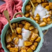 Air fryer apples served with ice cream in 2 bowls.