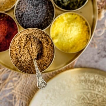 Cumin powder stored in an indian masala dabba along with other spices.