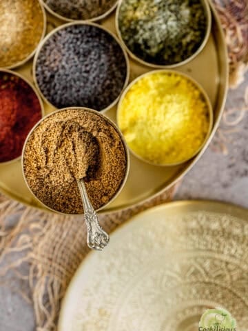 Cumin powder stored in an indian masala dabba along with other spices.