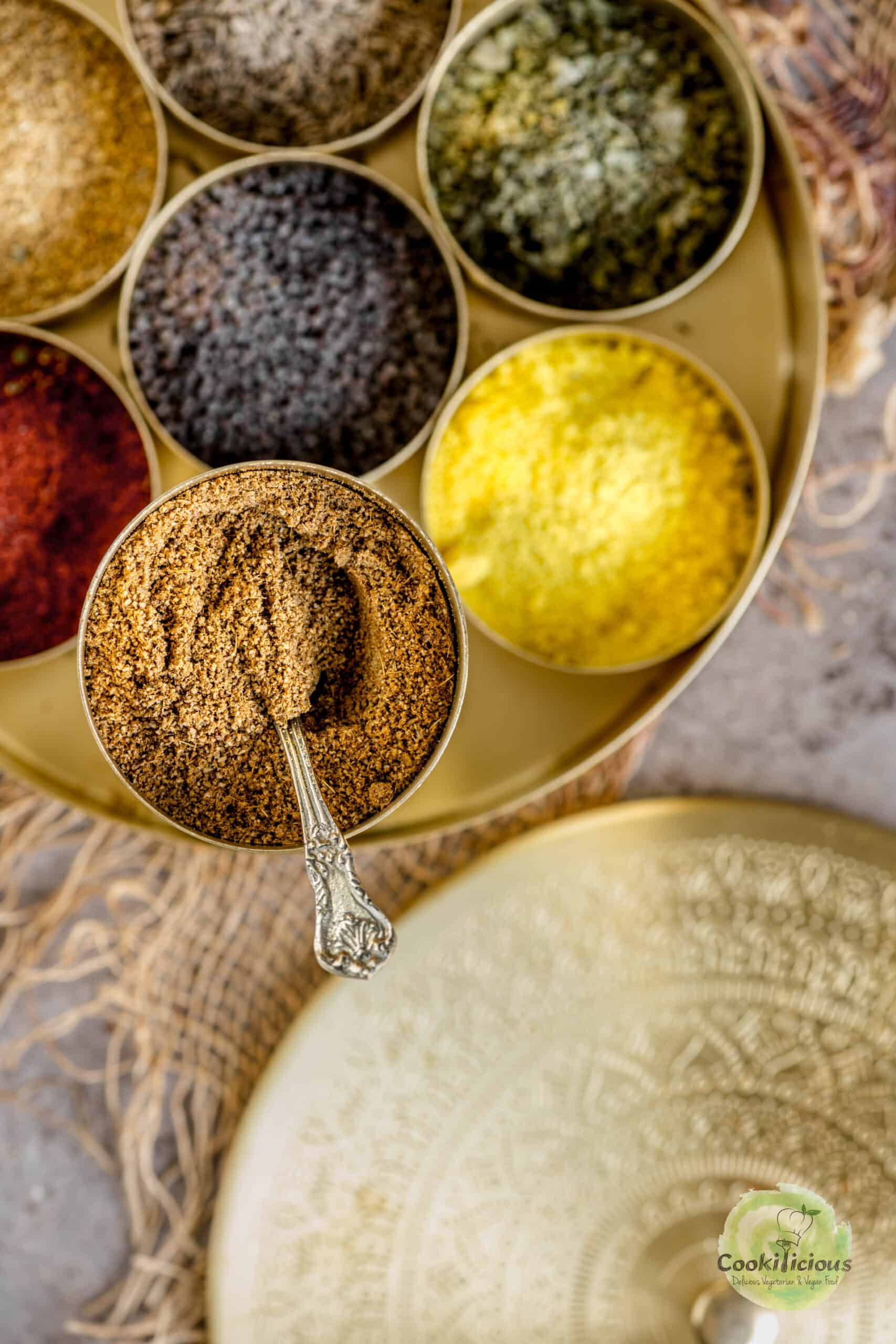 Cumin powder stored in an indian masala dabba along with other spices.