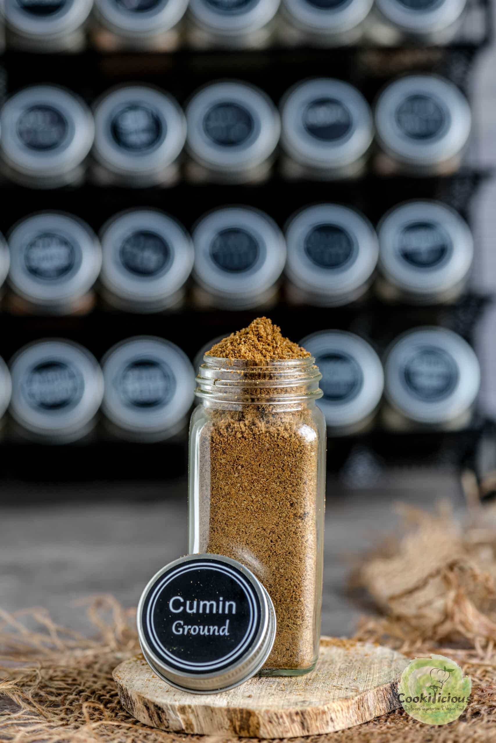 Roasted ground cumin stored in a small glass container.