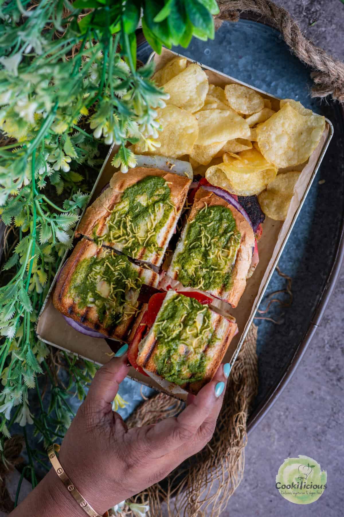 Bombay Grilled Sandwich served in a platter with chips on the side.