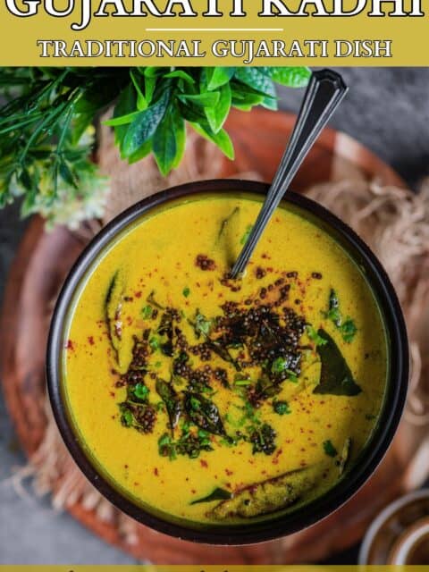 yellow Gujarati Kadhi made with besan and dahi served in a bowl with tadka on top and text at the top and bottom.