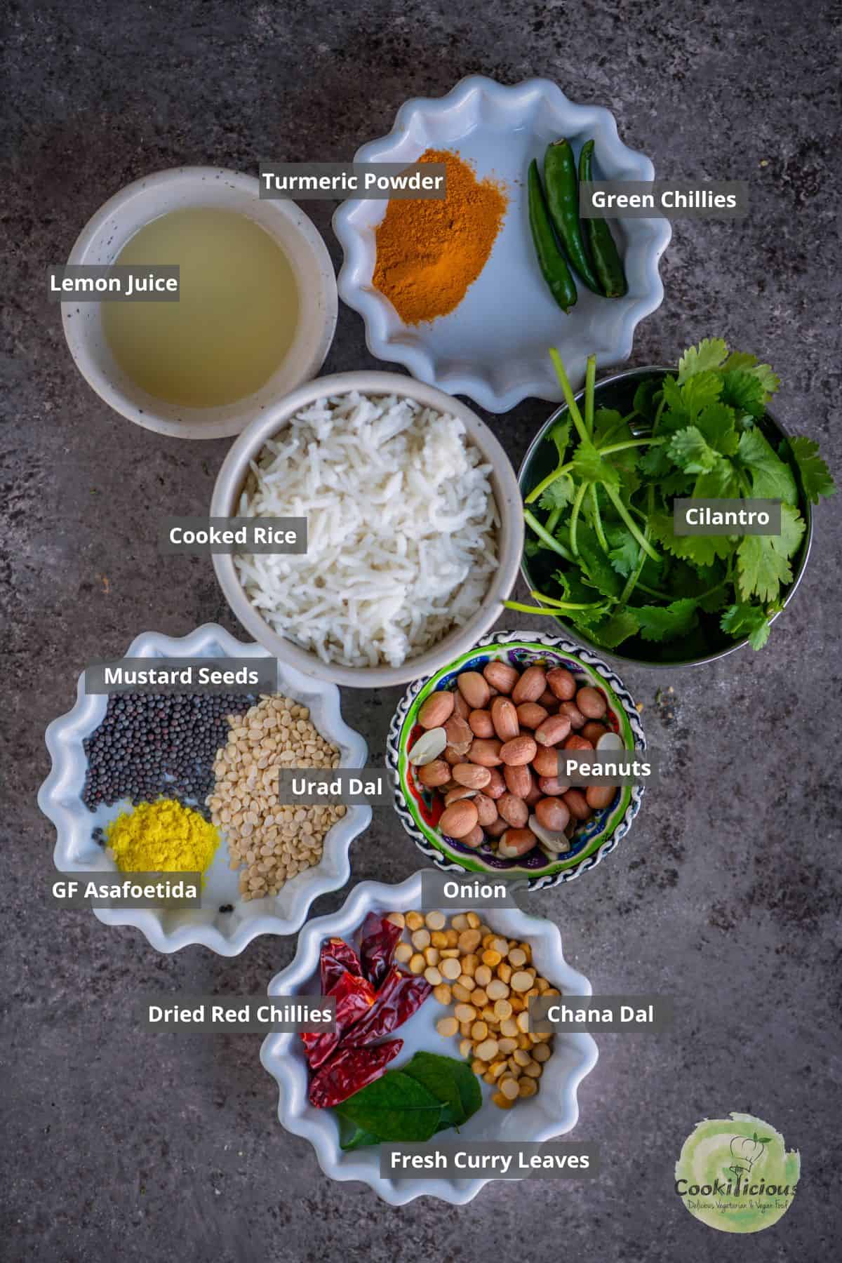 All the ingredients needed to in the South Indian Lemon Rice recipe are placed on a table with labels on them.