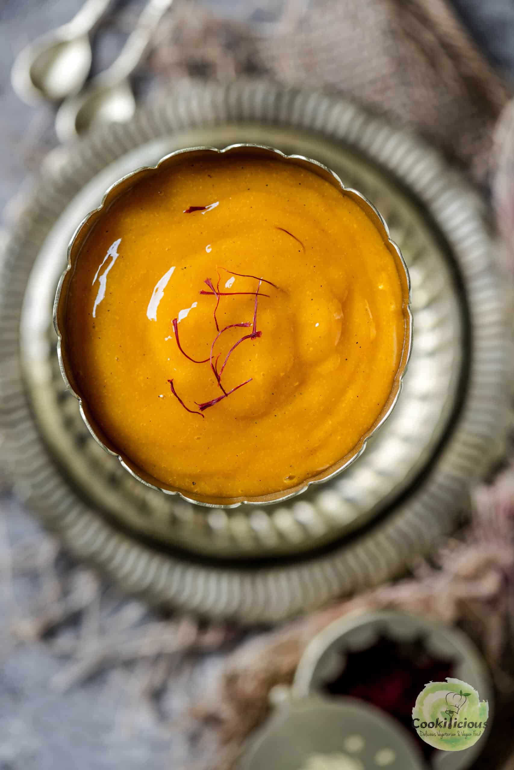 Smooth and creamy aamras served in a traditional bowl.