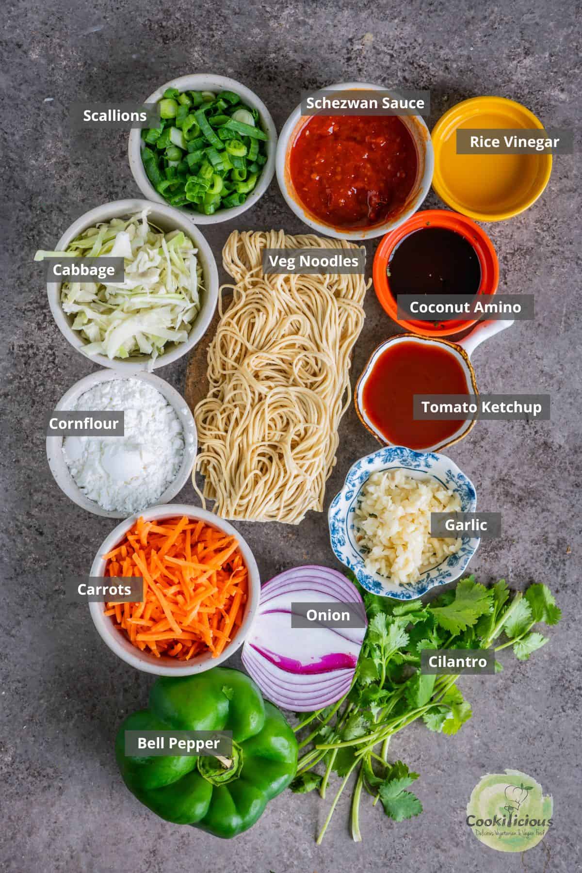 All the ingredients needed to make Street-Style Chinese Bhel placed on a table with labels on them. 