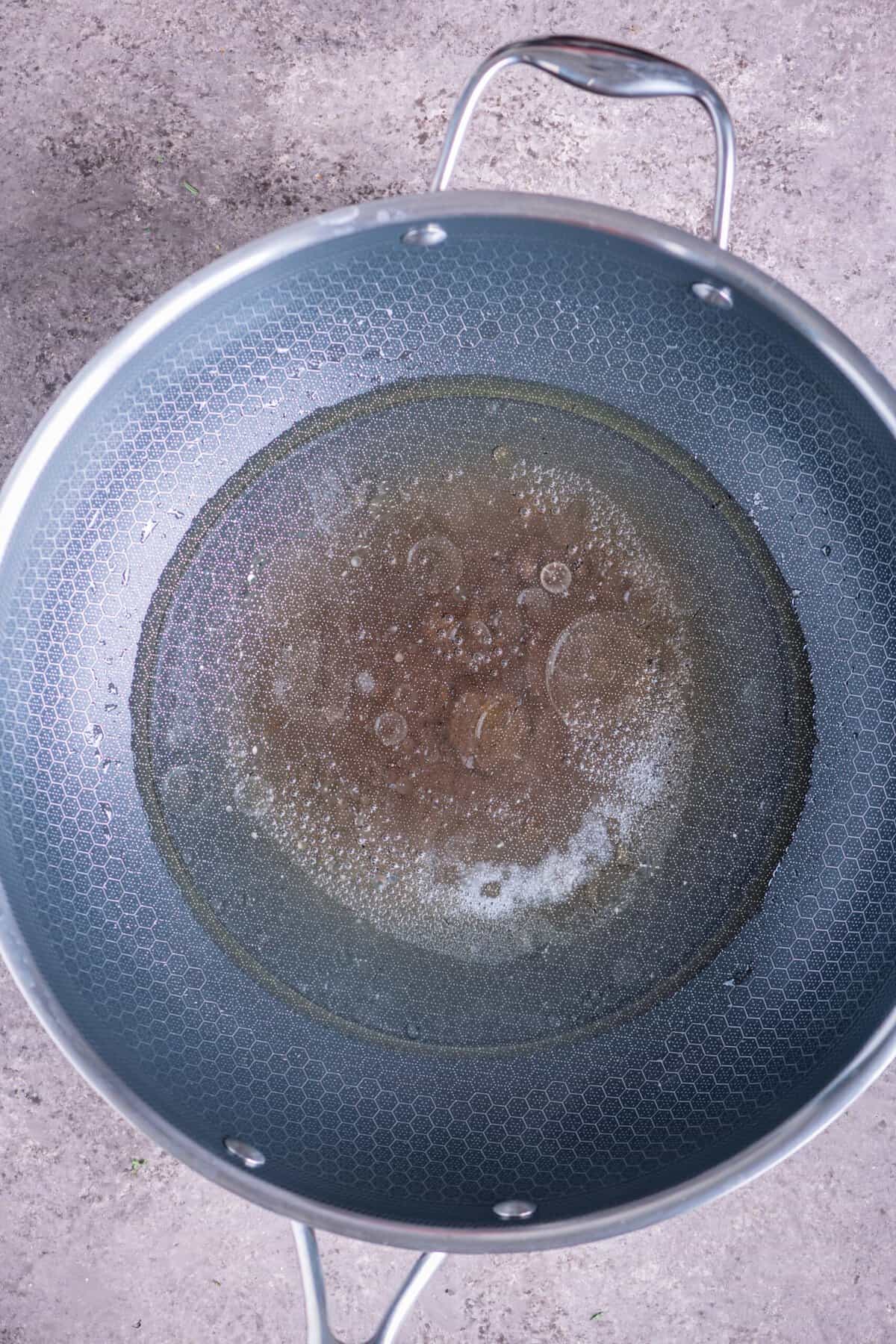 Water boiling in a pan with salt and gingelly oil.