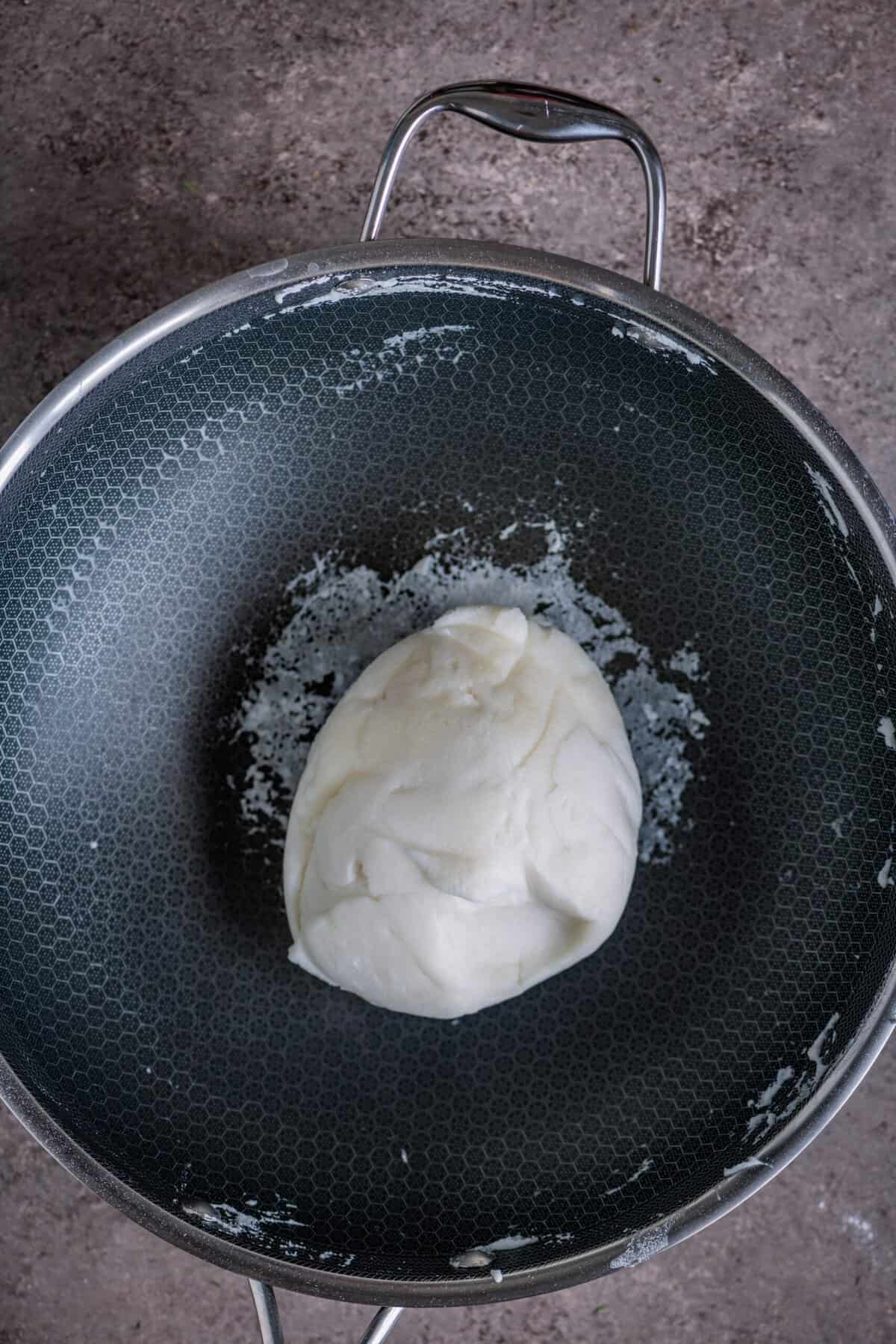 Rice flour dough thickening and pulling away from the sides of the pan.