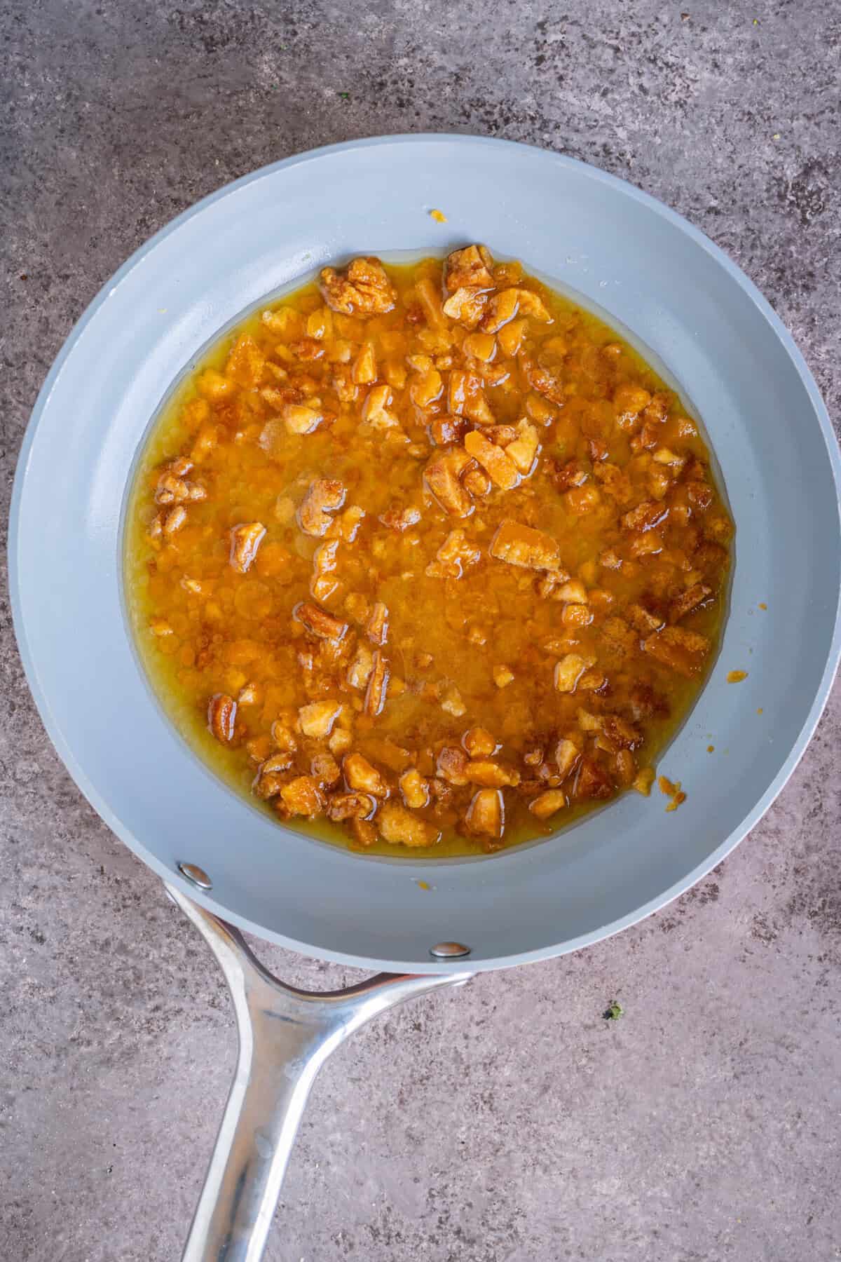 Water being poured into the jaggery and ghee mixture.