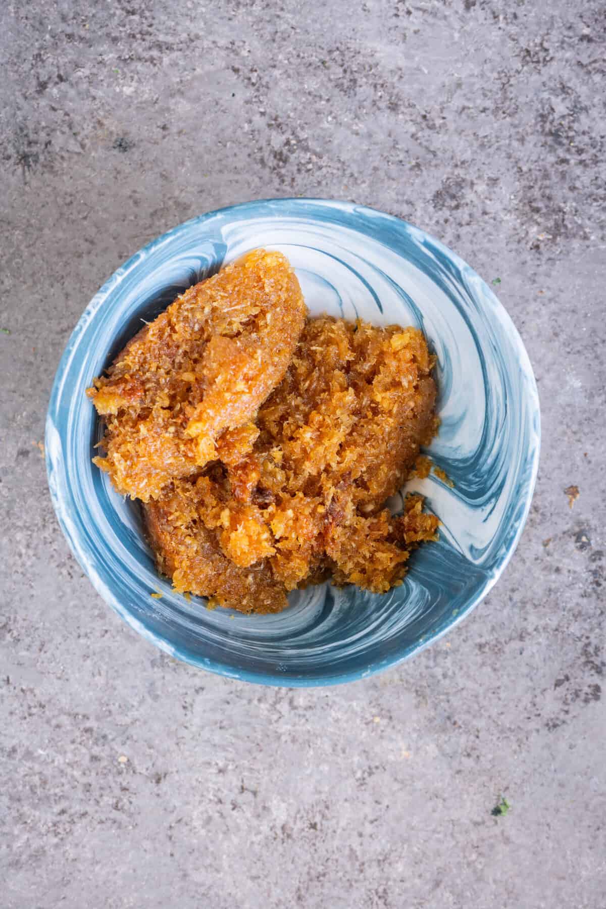 Thengai Pooranam coconut jaggery stuffing rolled into balls in a bowl.