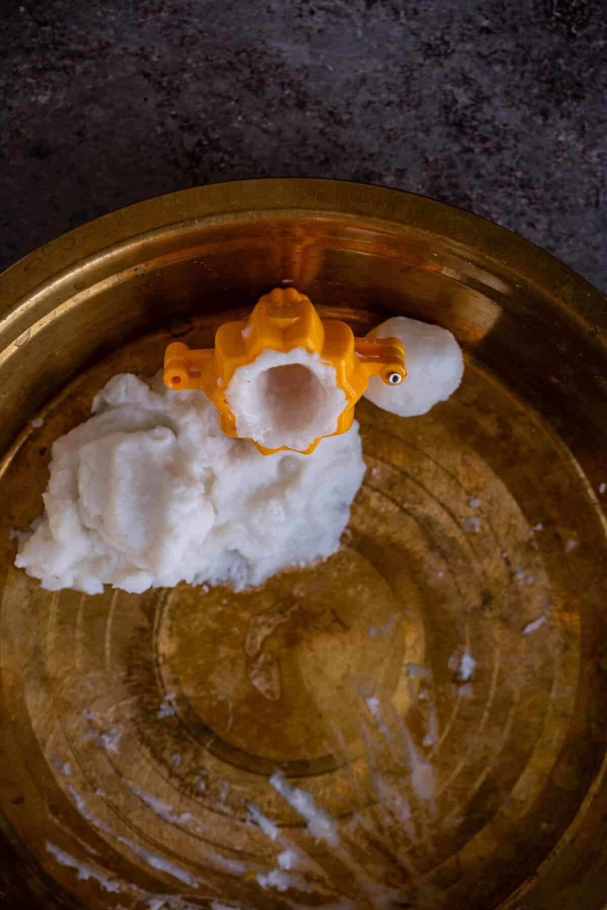 Dough pressed evenly along the mold to form a hollow cavity.