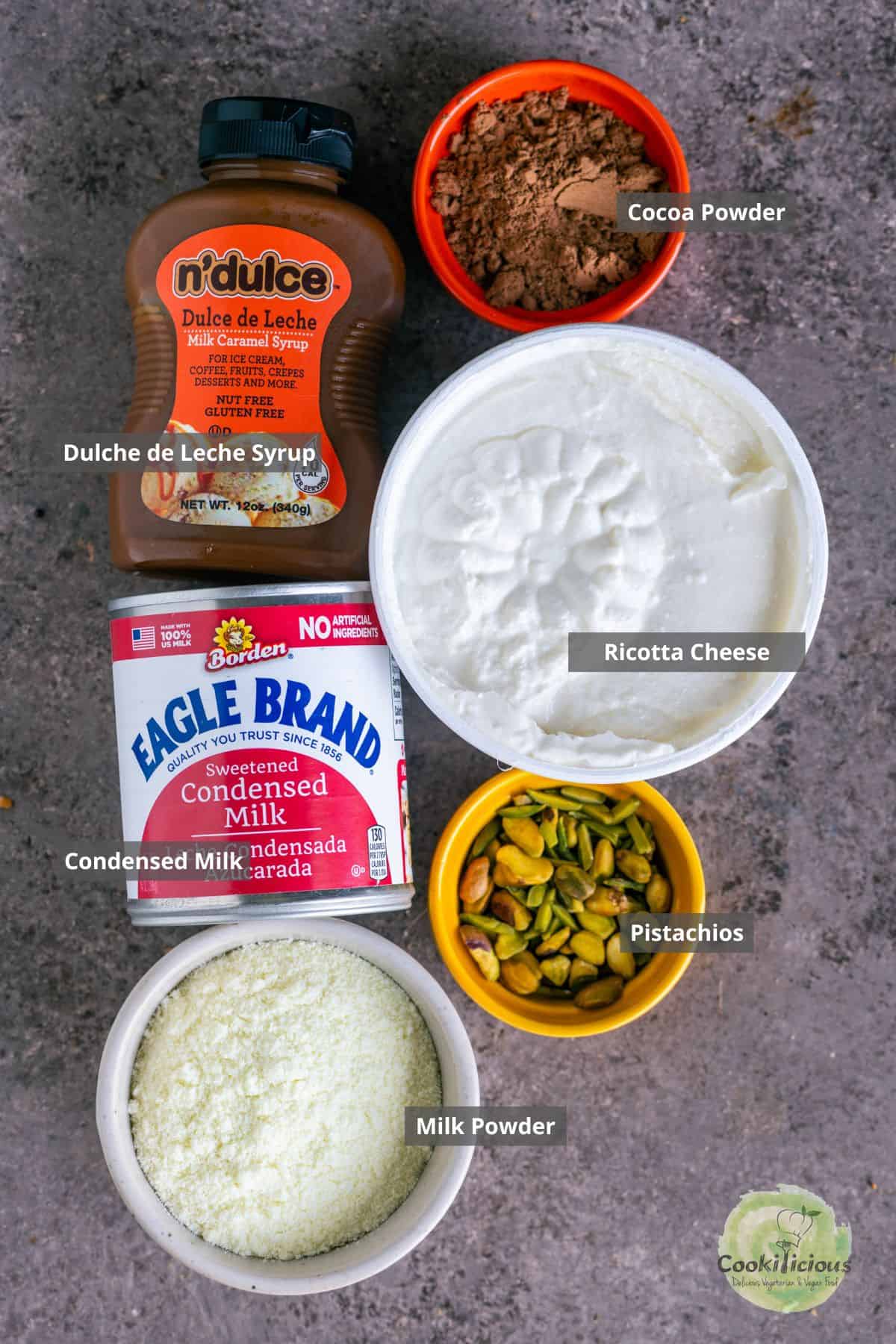 All the ingredients needed in the milk-based Indian dessert - Caramel Kalakand recipe placed on a table with labels on them.