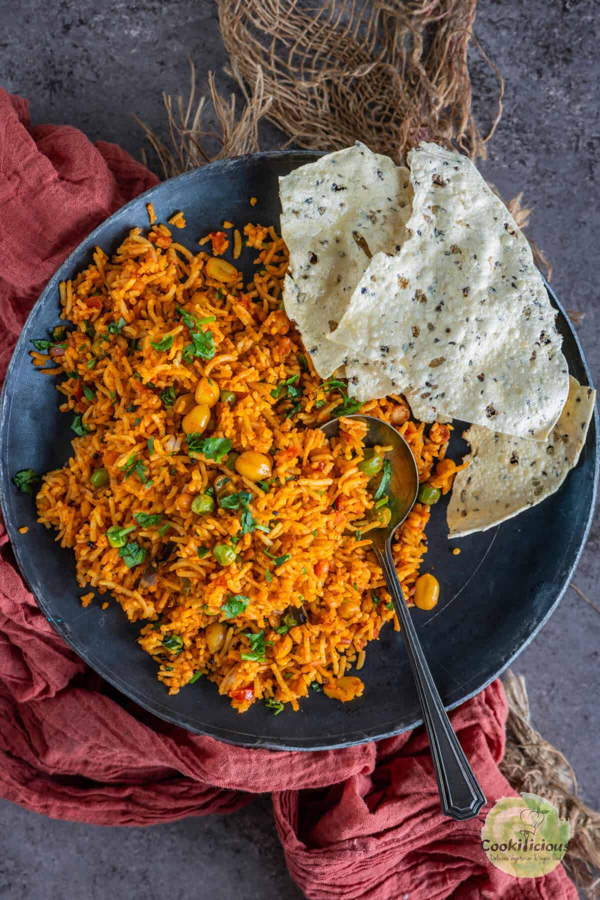 South Indian Tomato Rice (Thakkali Sadam) served with papad.