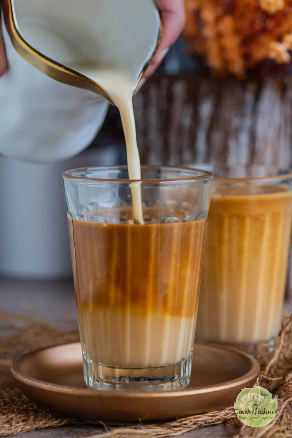 Homemade Starbucks copycat mocha latte in a glass mug with oat milk and espresso.