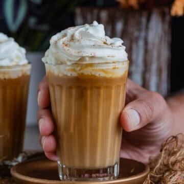 Vegan White Chocolate Mocha Latte topped with whipped cream and cinnamon.